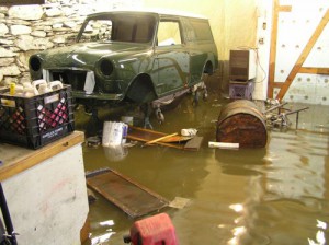 The flood waters recede around a Mini panel van