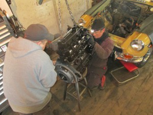 John & Steve prep a rebuilt MGB engine for installation