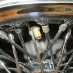 pinched valve stem in a spline drive wire wheel